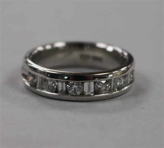 A modern 14ct white gold and diamond half eternity ring, set with round and baguette cut diamonds, size N.